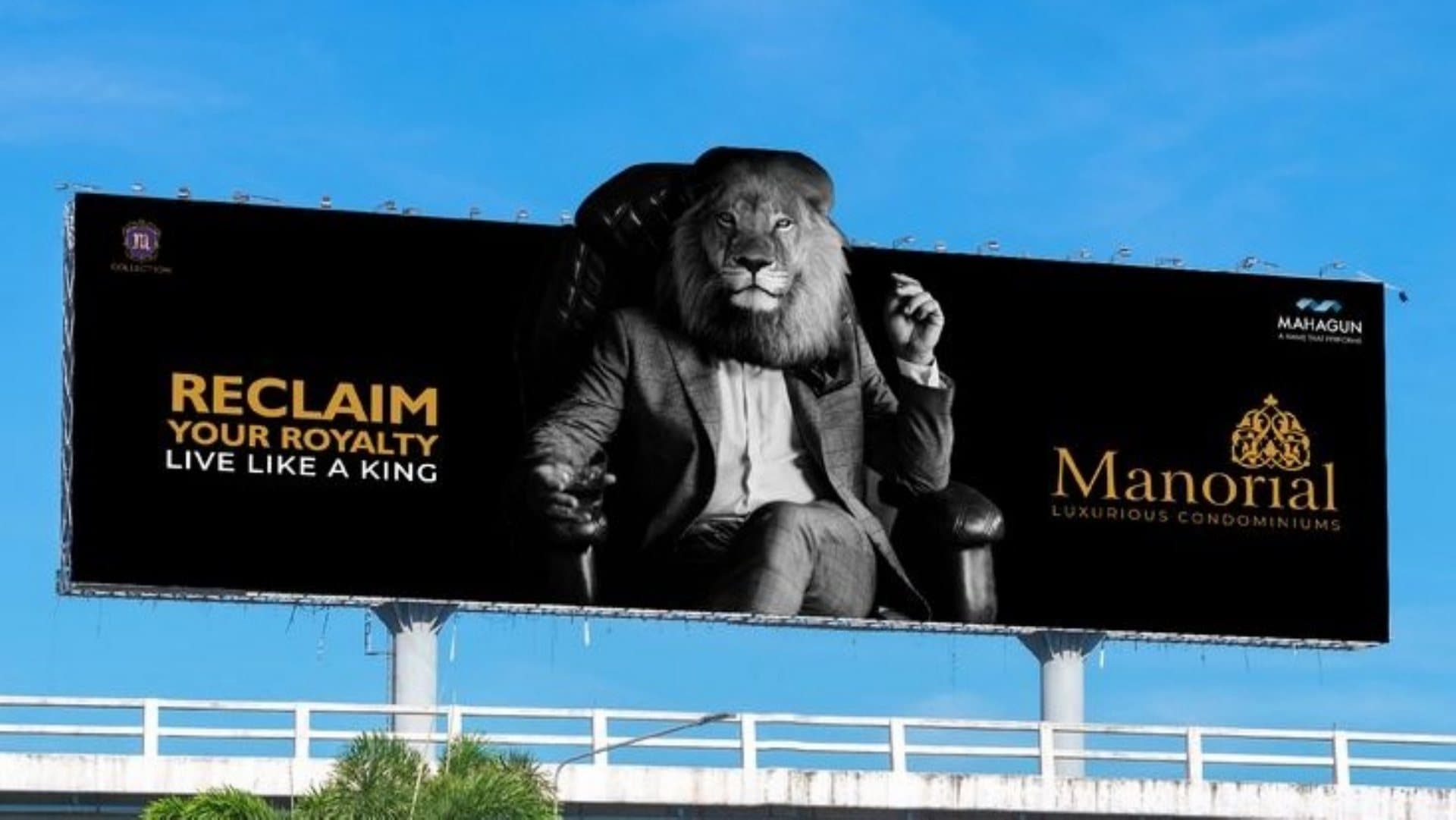 Mahagun Manorial hoarding with a lion in a suit, Reclaim Your Royalty